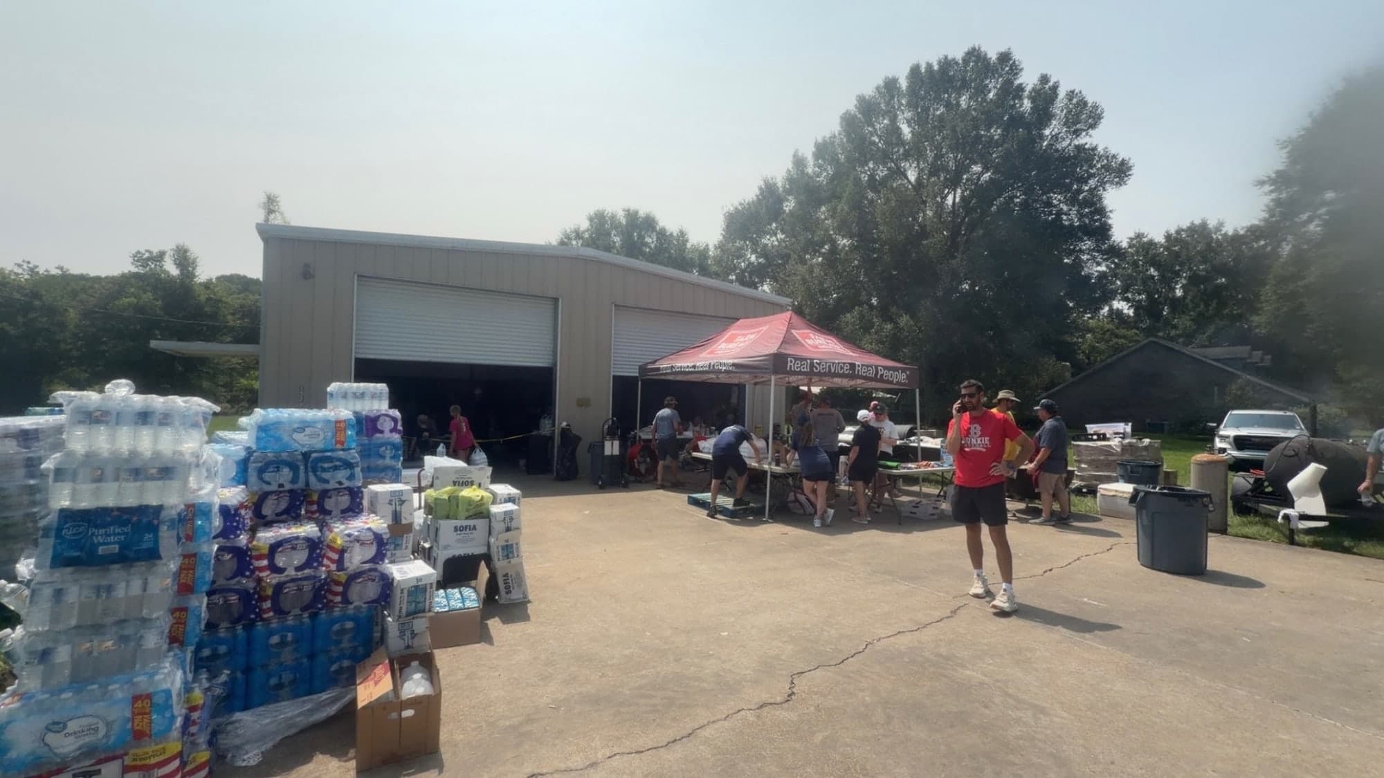 Relief supplies and volunteers gathered at a local distribution site